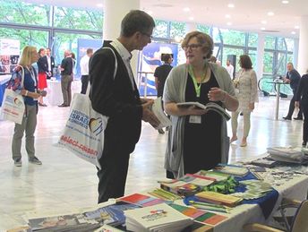 ConAct-Mitarbeiterin Rebecca Görmann erklärt interessierten Fachkräften die Publikationen (Foto © ConAct) ConAct-Mitarbeiterin Rebecca Görmann erklärt interessierten Fachkräften die Publikationen