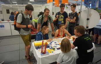 Jugendliche sitzen an einem Tisch und versuchen ihren Namen auf hebräisch zu schreiben.