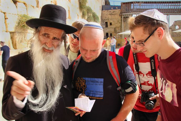 Ein orthodoxer Gläubiger unterhält sich mit Jugendlichen einer Begegnungsreise